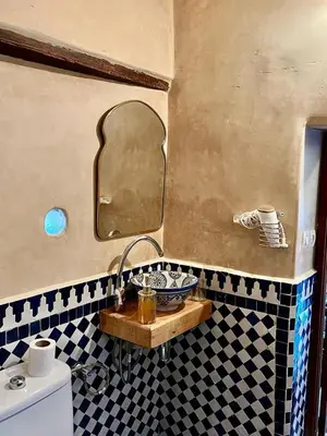 a bathroom with a sink and a mirror at DAR Naima in Fès