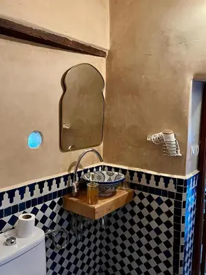 a bathroom with a sink and a mirror at DAR Naima in Fès