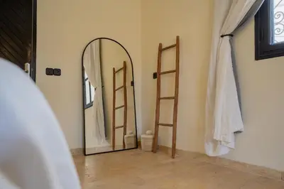 a room with a mirror and a dressing room at Villa Daïs - Marrakech in Marrakech
