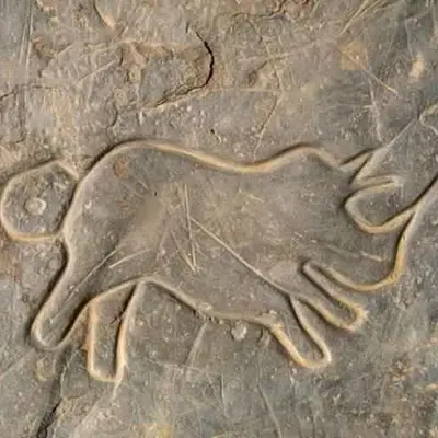 a bas relief of a dog on a rock at Serdrar Camp in Timganine