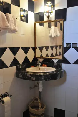 a bathroom with a sink and a mirror at Serdrar Camp in Timganine