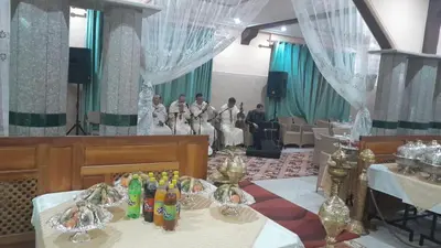 a group of people standing in a room with tables at Hotel Opéra Azrou in Azrou