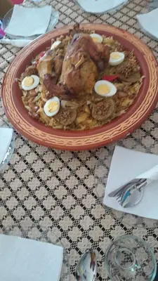 a plate of food with eggs on a table at Hotel Opéra Azrou in Azrou