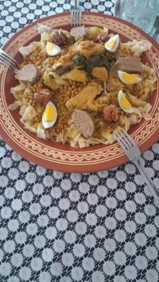 a plate of food with eggs on a table at Hotel Opéra Azrou in Azrou
