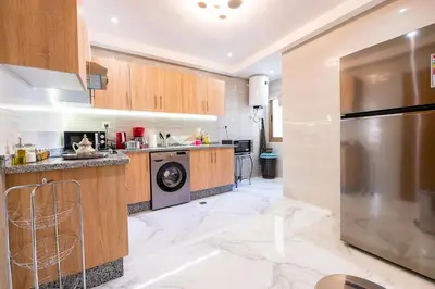 a kitchen with a washer and dryer at Cozy Apartment in new town in Fès