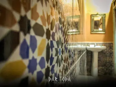 a bathroom with a sink and a mosaic wall at Dar Toda - Zagora guest house in Zagora
