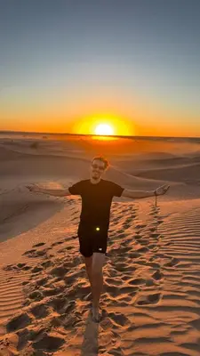 a person walking on the beach at sunset at Dar Toda - Zagora guest house in Zagora