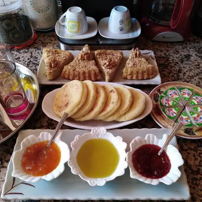 a table with plates of pastries and dipping sauce at Gite Tamounte in Tabant