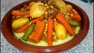 a bowl of food with carrots and other vegetables at Gite Tamounte in Tabant