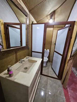 a bathroom with a sink and a toilet at Najma Luxury Camp in Merzouga