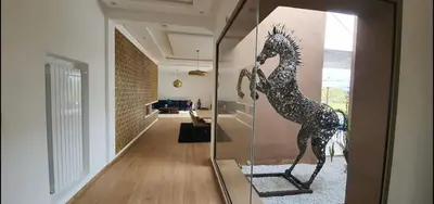 a glass display case with a statue of a horse at Villa à 30 mn de Marrakech. in El Aouina