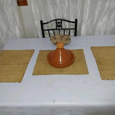 a table with a white table cloth with a vase on it at Cozy Appartement in Midelt in Midelt