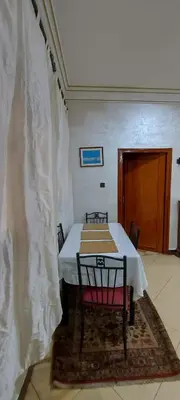a dining room with a table with a white curtain at Cozy Appartement in Midelt in Midelt
