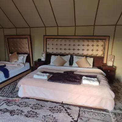 a bedroom with a large bed in a tent at Overnight Luxury Camp in Merzouga