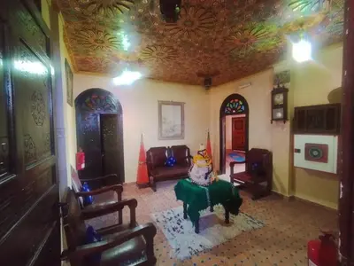 a living room with a couch and a table at Riad Andalousse in Meknès