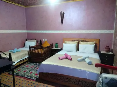a bedroom with two beds with stuffed animals on them at Riad Andalousse in Meknès