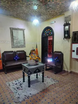 a living room with a couch and a table at Riad Andalousse in Meknès