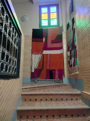 a group of carpets on the wall of a synagogue at Riad Andalousse in Meknès