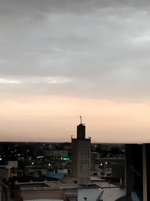 a view of a city skyline at sunset at Riad Andalousse in Meknès