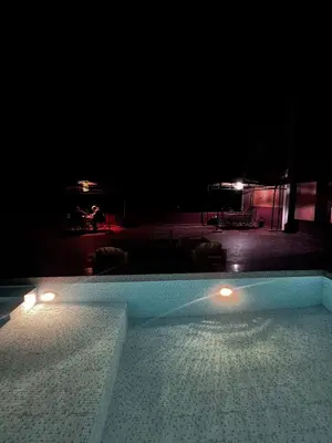 a swimming pool at night with lights on it at Appartement In Ksar Ait Ben Haddou in Aït Ben Haddou