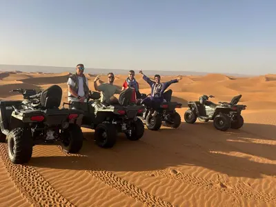 a group of people riding atvs in the desert at Dar Yaya & excursion - M'Hamid El Ghizlane in Mhamid