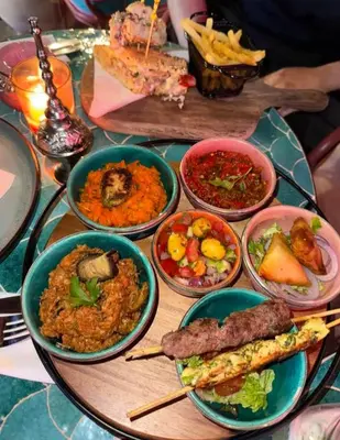 a table with many bowls of food on it at Dar Yaya & excursion - M'Hamid El Ghizlane in Mhamid