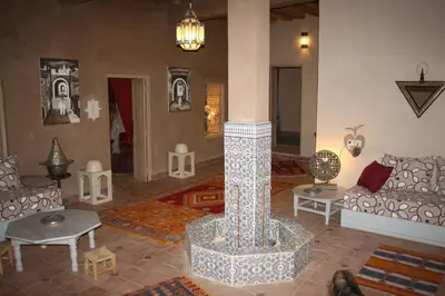 a living room with a couch and a fireplace at Dar Pienatcha in Zagora