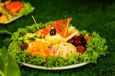 a plate of food with rice and vegetables on the grass at Complexe El Bassatine in Beni Mellal