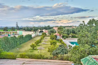 an aerial view of a park with a pool at Complexe El Bassatine in Beni Mellal