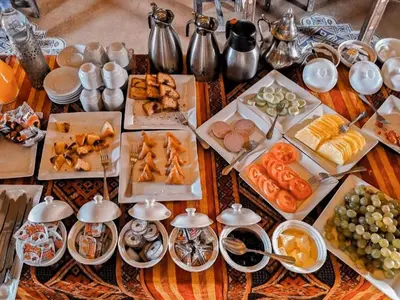 a table with many different types of food on it at Gorgeous Luxury Camp in Merzouga