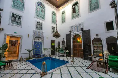 a courtyard with a pool in a building at Palais Chahd Luxury in Fès