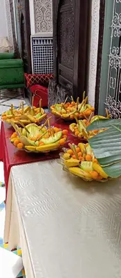 a table with bananas and other fruits on it at Palais Chahd Luxury in Fès