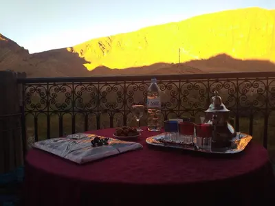 a table with a plate of food on top of a fence at La Petite Gorge, Hôtel & Restaurant Todra Gorge in Tinerhir
