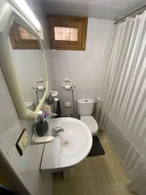 a white bathroom with a sink and a toilet at Cozy apartment near city center in Fès