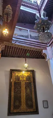 a rug hanging on a wall in a room at RIAD DAR DIWAN in Fès
