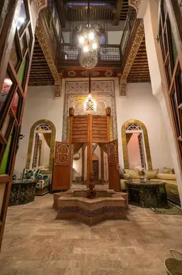 a living room with a large room with a ceiling at RIAD DAR DIWAN in Fès