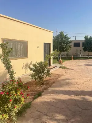 a building with flowers in front of a building at Amazing house separate of Villa with Swimming Pool in Marrakech