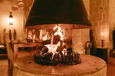 a fireplace in a room with fire in it at L'Ma Lodge in Skoura