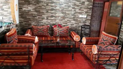a living room with couches and a table with pillows at شقق للكراء اليومي بالرشيدية Errachidia in Er Rachidia