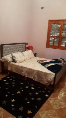 a bedroom with a bed with stars on it at شقق للكراء اليومي بالرشيدية Errachidia in Er Rachidia
