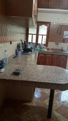 a kitchen with a granite counter top in a room at شقق للكراء اليومي بالرشيدية Errachidia in Er Rachidia