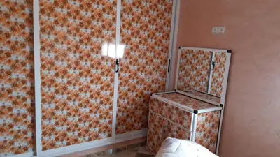 a bedroom with an orange and white patterned wall at شقق للكراء اليومي بالرشيدية Errachidia in Er Rachidia