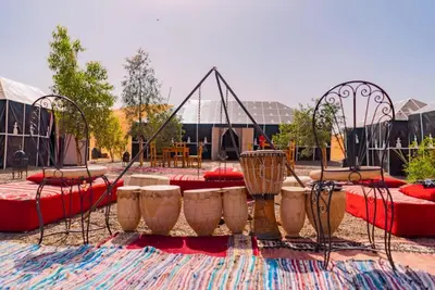 a playground with tables and chairs in a park at Rachid Luxury Camp in Merzouga