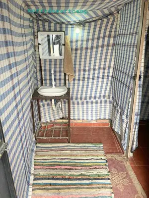 a small bathroom with a sink and a mirror at Merry Desert Camp in Merzouga