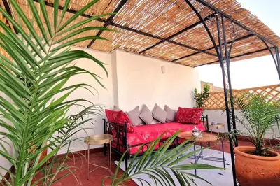 a living room with a red couch and some plants at Entire Private House in Fez Medina! in Fès