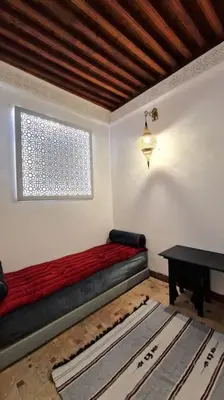 a room with a couch and a window and a table at Entire Private House in Fez Medina! in Fès