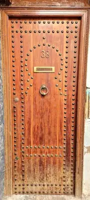 a brown wooden door with a handle on it at Entire Private House in Fez Medina! in Fès