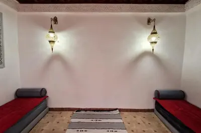 a room with two beds and two lights on the wall at Entire Private House in Fez Medina! in Fès