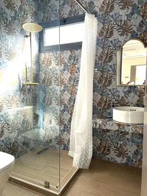 a bathroom with a shower with a toilet and a sink at Villa Naouma in Marrakech