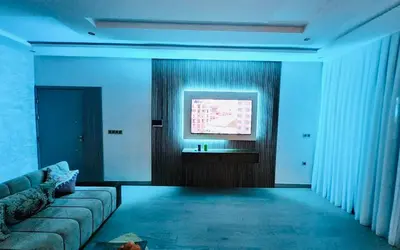 a living room with a couch and a flat screen tv at Villa Naouma in Marrakech